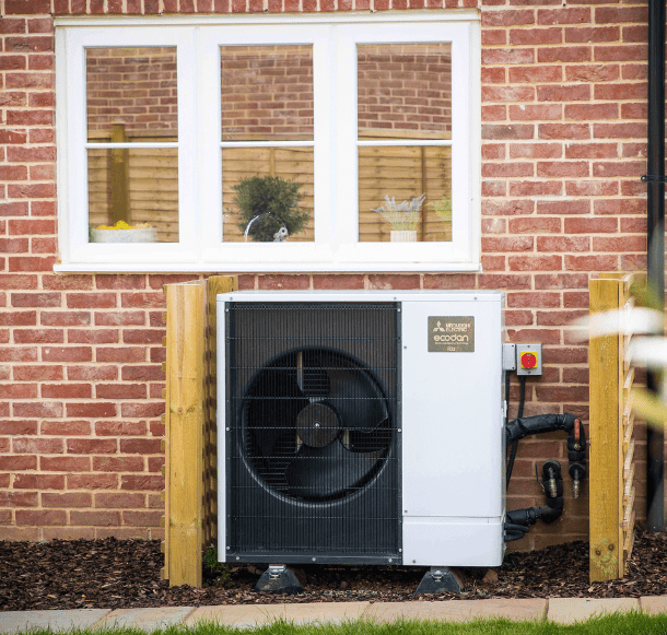 A Domestic Air Source Heat Pump installed on the side of a house