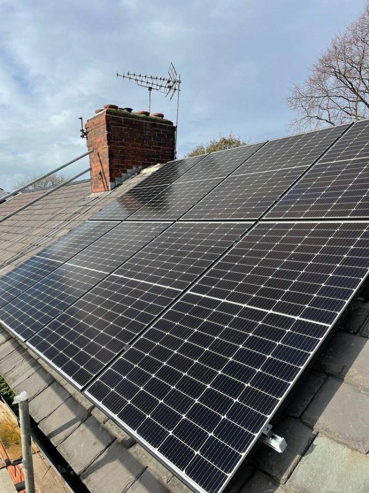 View of the rear of a house with a set of solar panels installed